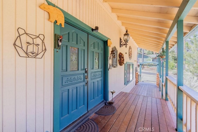 view of exterior entry with covered porch