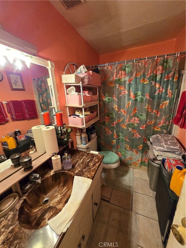 full bath with tile patterned flooring, toilet, a shower with shower curtain, vanity, and visible vents