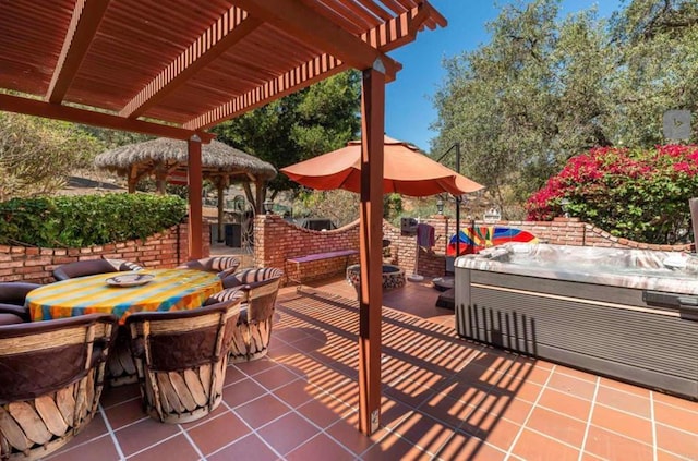 view of patio / terrace with outdoor dining area, a hot tub, and a pergola