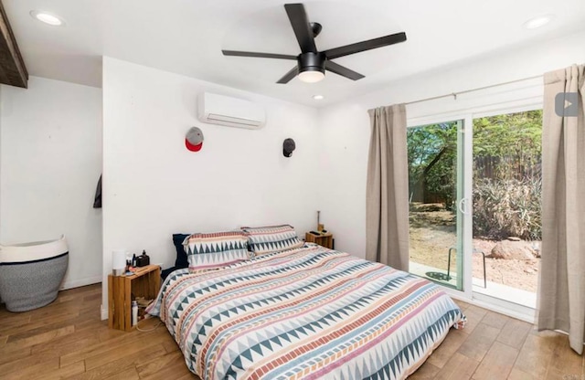 bedroom featuring recessed lighting, an AC wall unit, ceiling fan, and wood finished floors