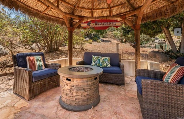 view of patio / terrace with a fire pit and a gazebo