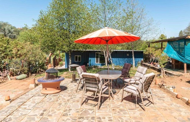 view of patio featuring a fire pit and outdoor dining area