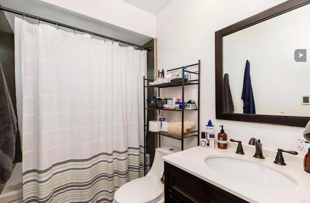 bathroom featuring toilet, a shower with curtain, and vanity