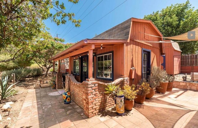 view of outbuilding featuring fence