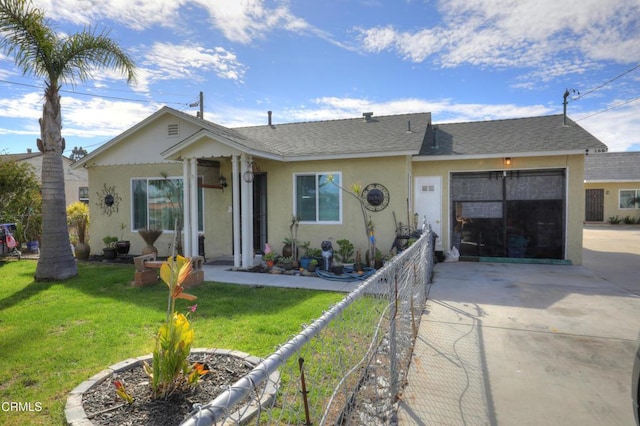 view of front of house with a garage, concrete driveway, fence, a front lawn, and stucco siding