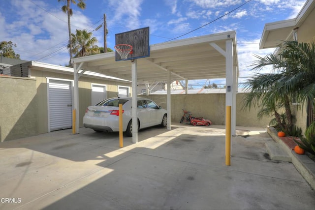 view of car parking featuring fence