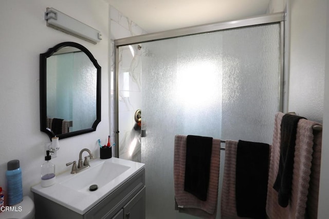 full bathroom with toilet, an enclosed shower, and vanity