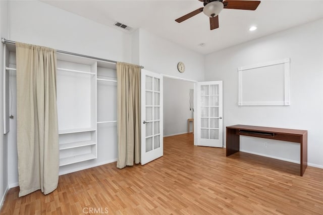 unfurnished bedroom with french doors, a closet, visible vents, light wood-style floors, and a ceiling fan