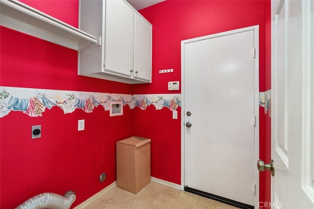 clothes washing area with cabinet space, electric dryer hookup, and baseboards