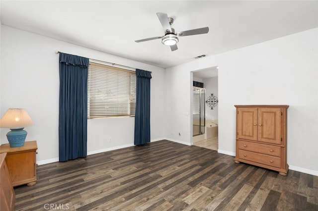 unfurnished bedroom featuring ensuite bathroom, wood finished floors, visible vents, and baseboards