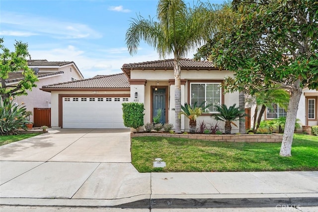 mediterranean / spanish-style house featuring a garage, concrete driveway, stucco siding, a tile roof, and a front yard