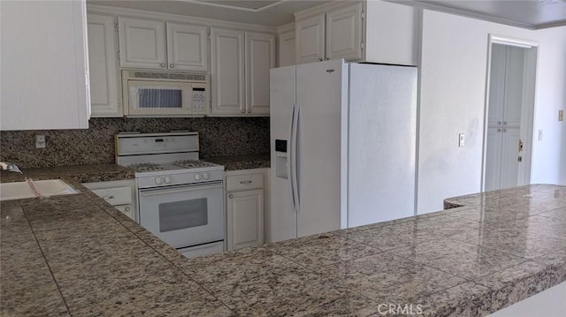 kitchen featuring tile countertops, decorative backsplash, white cabinetry, a sink, and white appliances