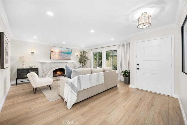 bedroom featuring recessed lighting, ornamental molding, baseboards, light wood-type flooring, and a lit fireplace