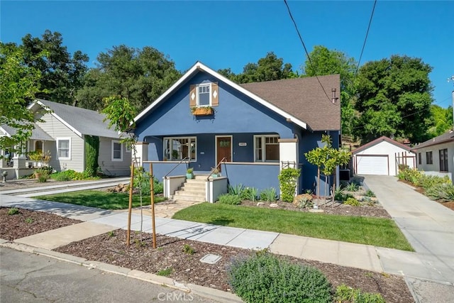 bungalow featuring stucco siding, driveway, covered porch, an outdoor structure, and a garage