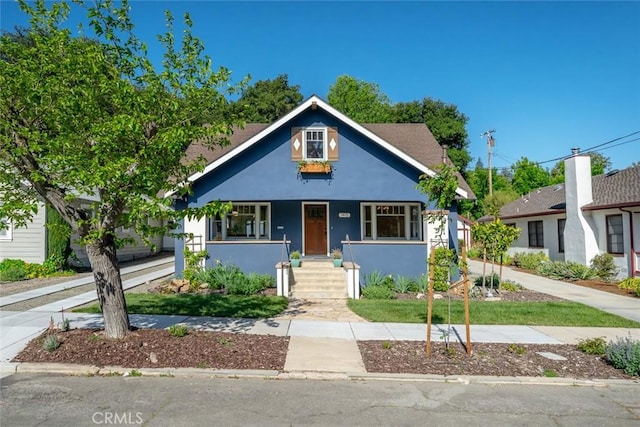 bungalow-style house featuring stucco siding and a porch