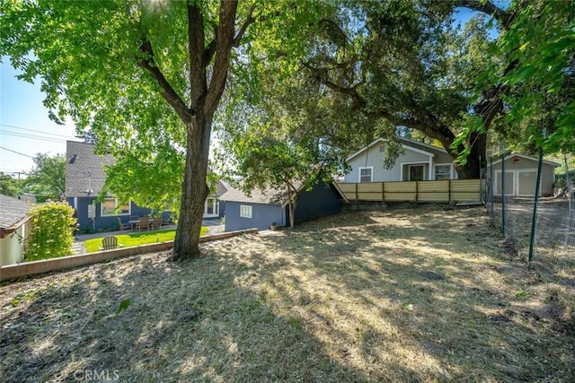 view of yard with an outbuilding and fence private yard