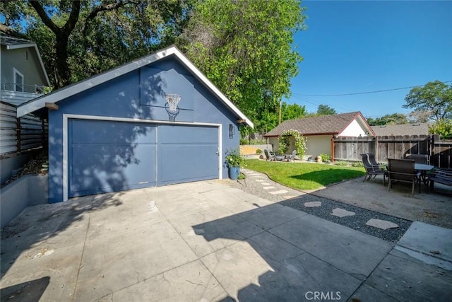 detached garage featuring fence