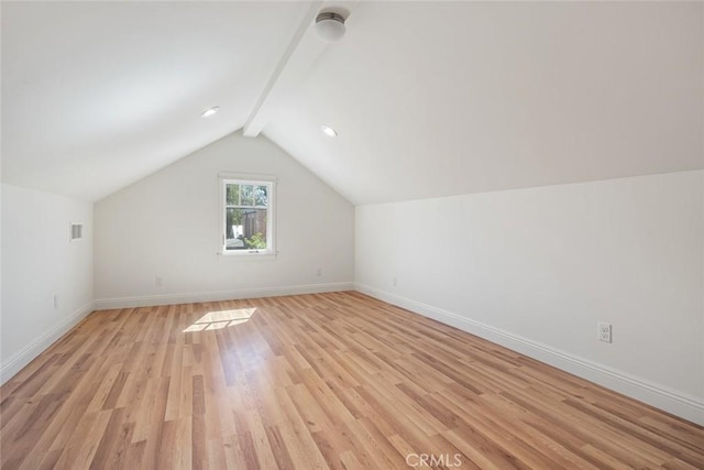 bonus room with visible vents, light wood-style flooring, lofted ceiling with beams, and baseboards