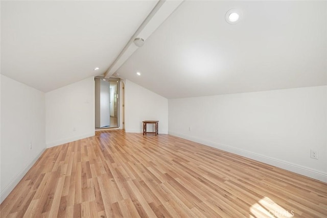 bonus room featuring light wood-type flooring, baseboards, and vaulted ceiling with beams