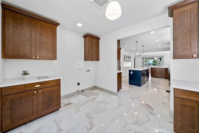 laundry area with hookup for a washing machine, cabinet space, marble finish floor, and visible vents