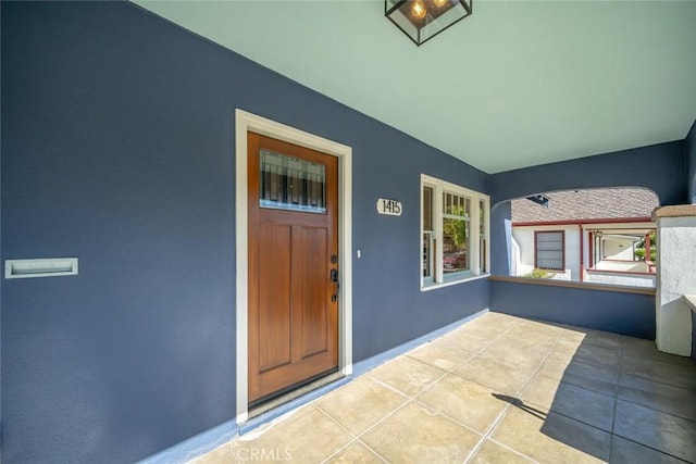 doorway to property featuring stucco siding