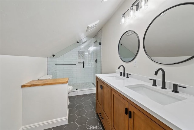 bathroom featuring tile patterned floors, toilet, lofted ceiling, and a sink