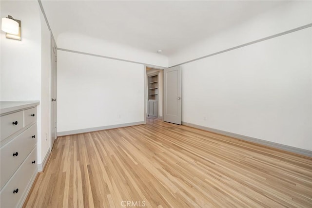 unfurnished bedroom with light wood-style floors and baseboards