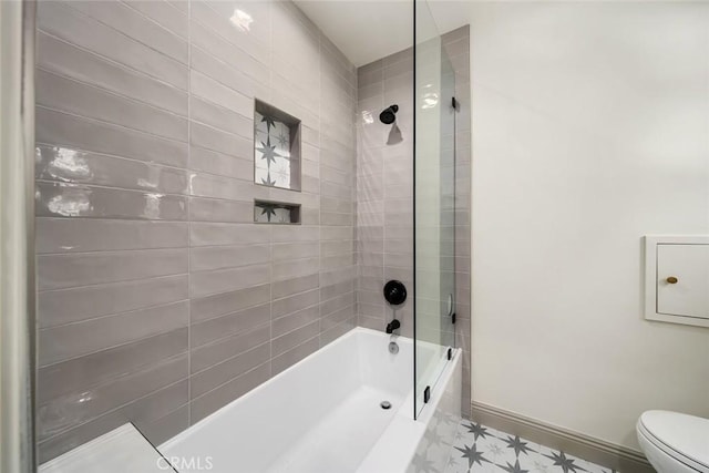 full bath featuring baseboards, toilet, and washtub / shower combination