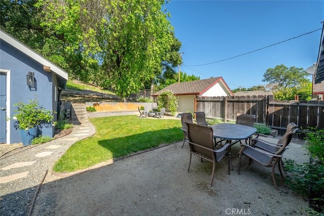 view of patio with outdoor dining space and fence