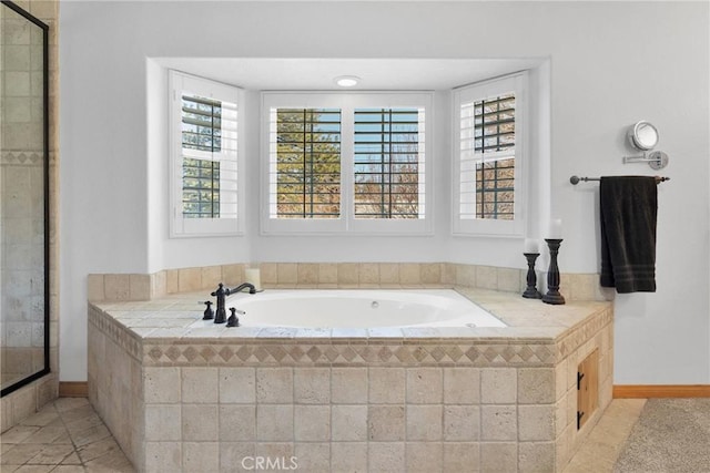 bathroom with tile patterned flooring, a shower stall, and a bath