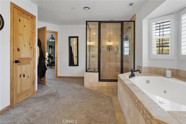 bathroom with a shower stall, visible vents, a textured ceiling, and a tub with jets