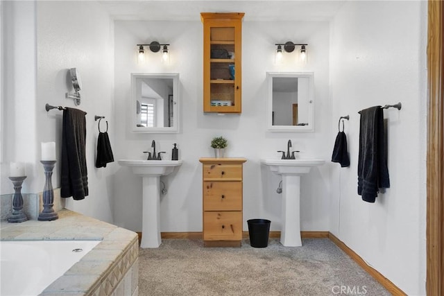 bathroom featuring baseboards and a bathtub