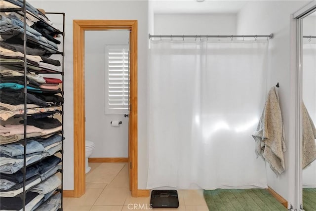 walk in closet featuring light tile patterned flooring