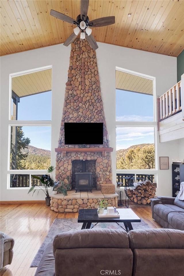 living area with wooden ceiling, plenty of natural light, and high vaulted ceiling