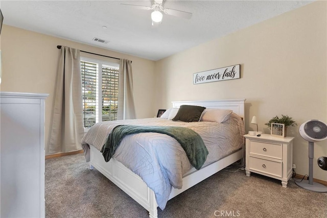 carpeted bedroom with a ceiling fan, visible vents, and baseboards