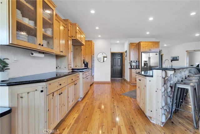 kitchen with stainless steel appliances, dark countertops, and recessed lighting