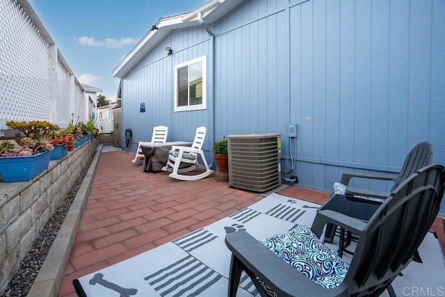 view of patio featuring cooling unit and fence