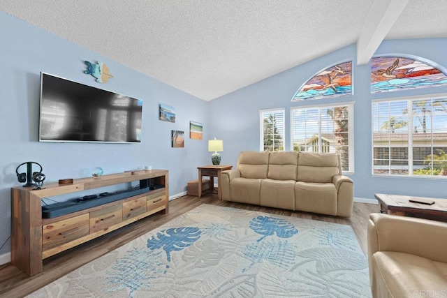 living room featuring a textured ceiling, vaulted ceiling with beams, baseboards, and wood finished floors