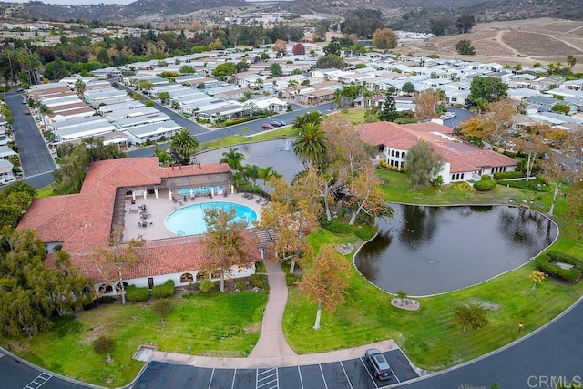 drone / aerial view featuring a residential view and a water view