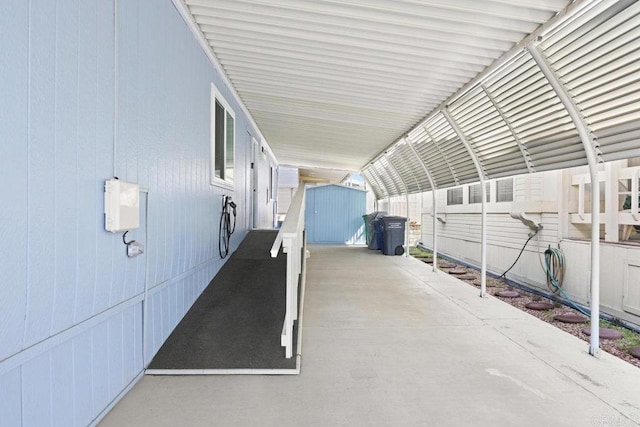 view of patio with an outbuilding and a storage unit