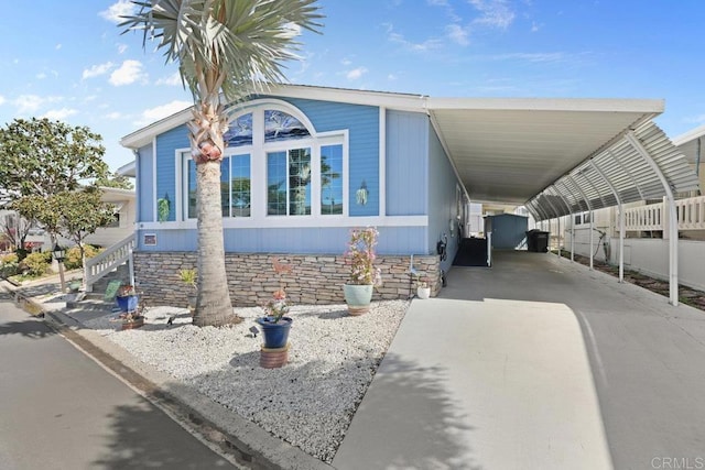 view of front of home with a carport and driveway