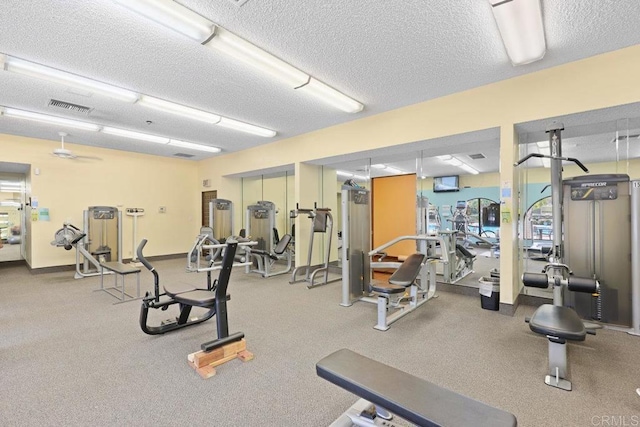 workout area featuring visible vents and a textured ceiling