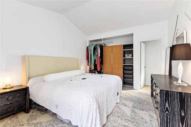 carpeted bedroom with vaulted ceiling