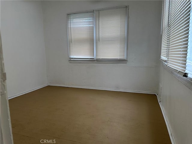 spare room featuring wood finished floors