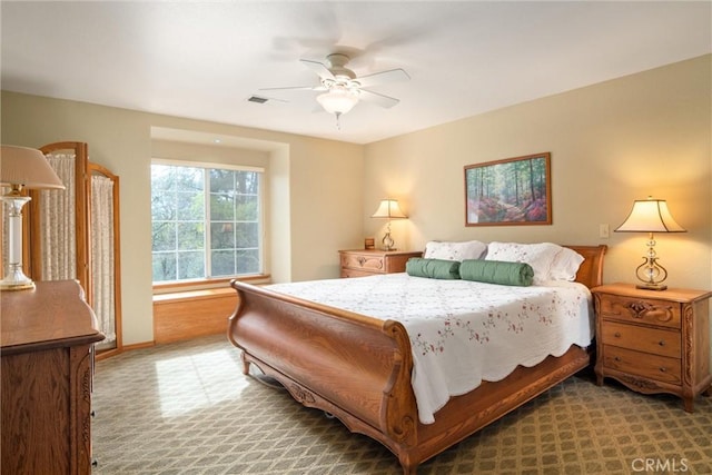 bedroom with ceiling fan, carpet floors, visible vents, and baseboards