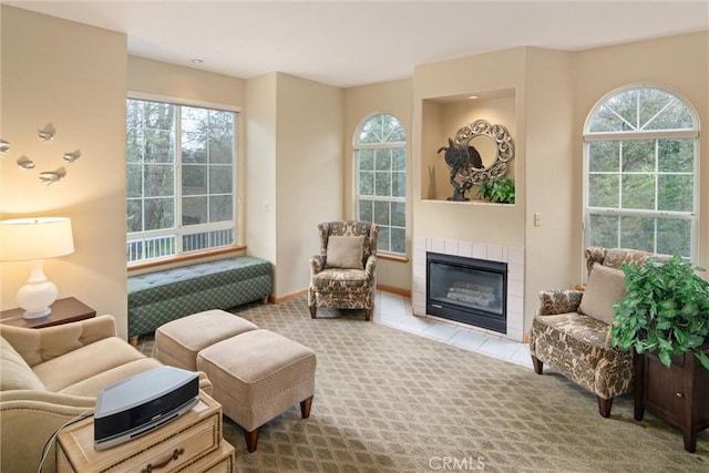 living area with carpet flooring, a fireplace, and baseboards