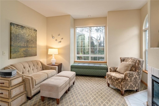 sitting room featuring a fireplace and tile patterned flooring