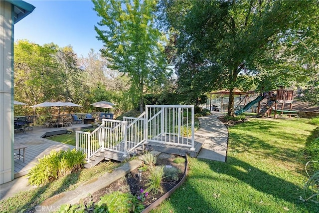 view of yard with a playground and a wooden deck