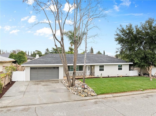 ranch-style house featuring driveway, a front lawn, fence, and stucco siding