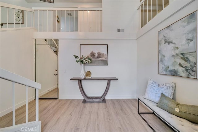 entrance foyer featuring visible vents, baseboards, and wood finished floors